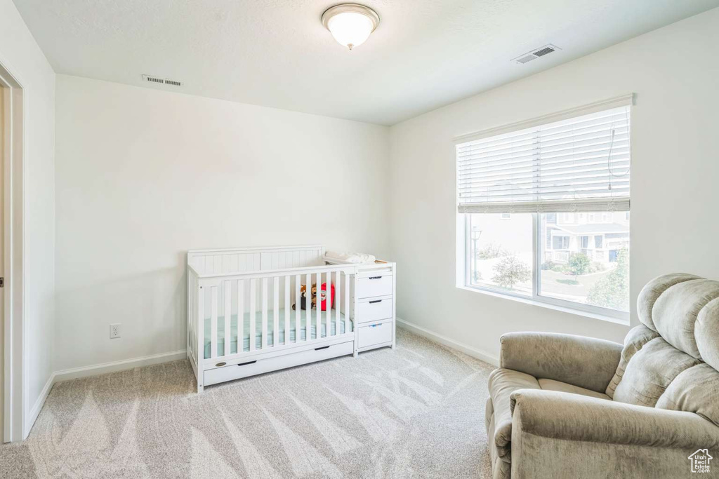 Carpeted bedroom featuring baseboards