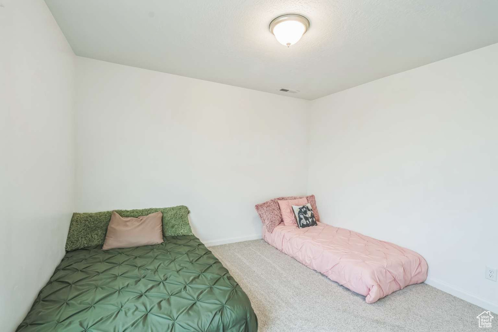Carpeted bedroom featuring baseboards
