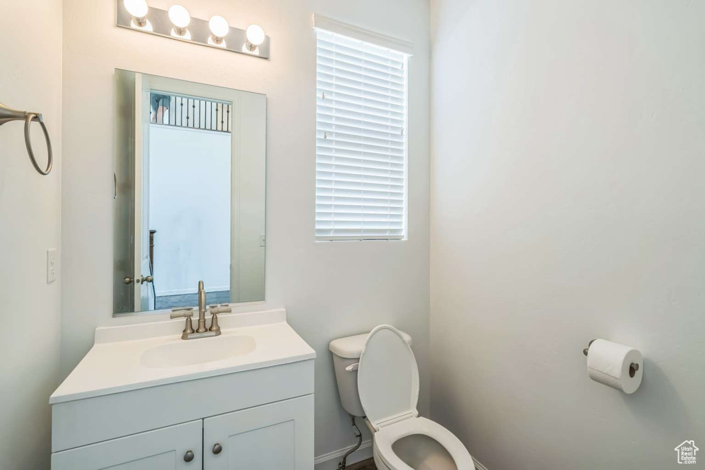 Half bath featuring toilet and vanity