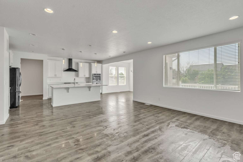 Unfurnished living room featuring recessed lighting and wood finished floors