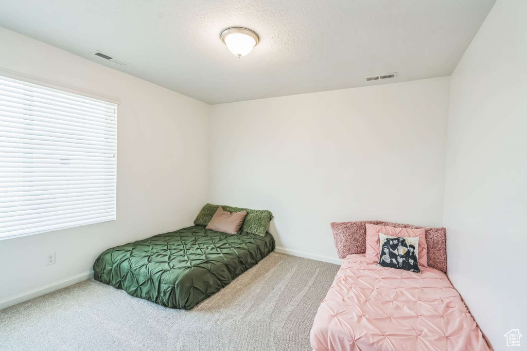 Carpeted bedroom with baseboards