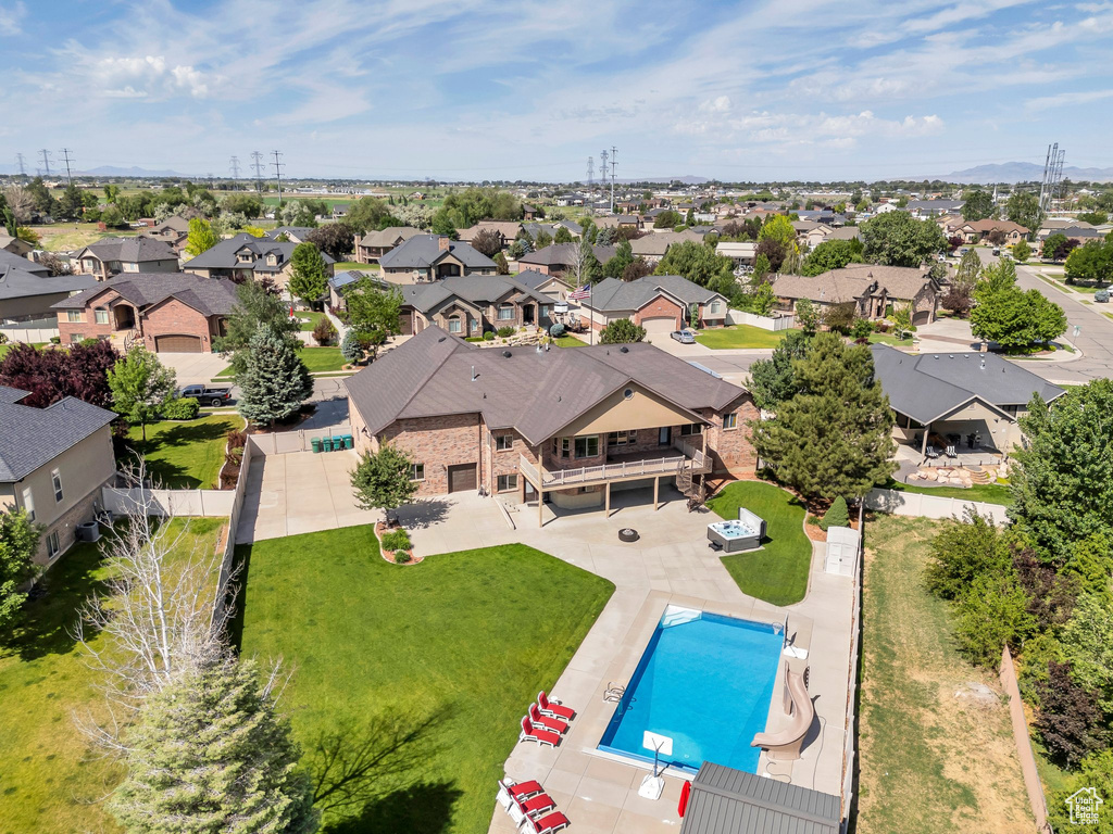 Aerial view of residential area featuring a pool