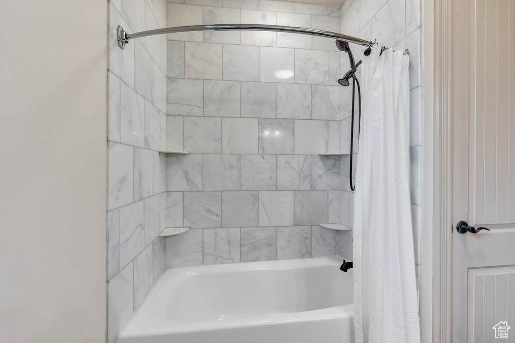 Bathroom featuring shower / bath combo with shower curtain