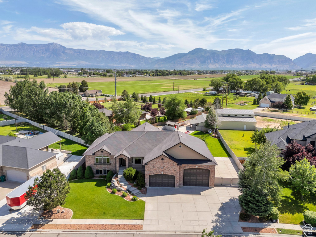 Aerial view of property and surrounding area featuring a mountain backdrop