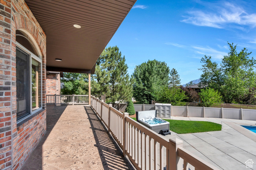 Fenced backyard with a pool and a patio