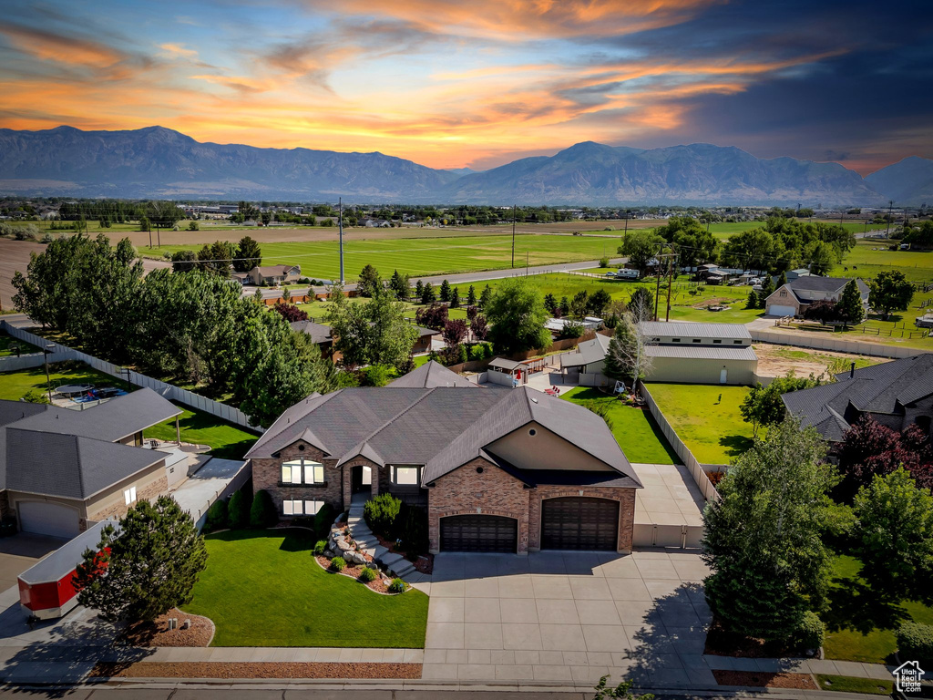 Aerial view of property and surrounding area featuring a mountainous background