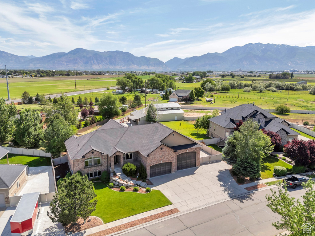 Aerial view of property and surrounding area featuring mountains