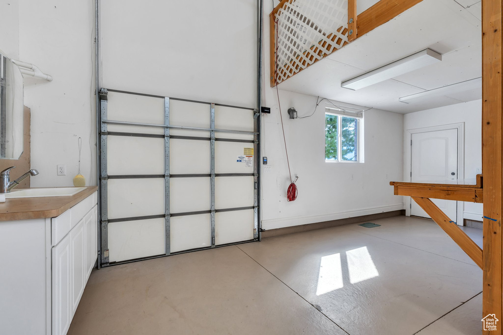 Garage with a sink and baseboards
