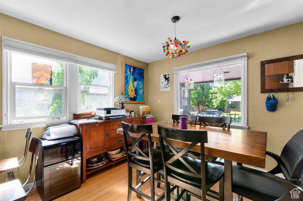 Dining area with light wood finished floors and a desk