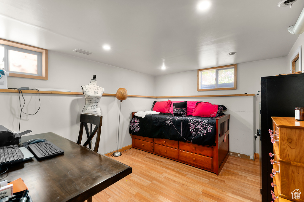 Bedroom with light wood-style floors, baseboards, an office area, and recessed lighting