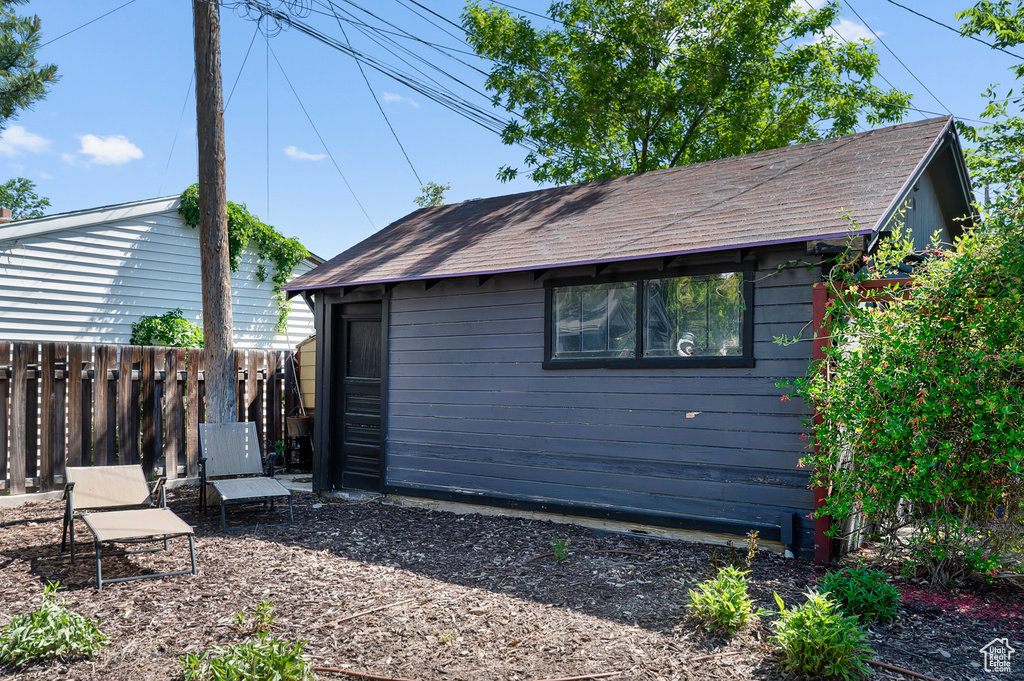 Back of property with an outbuilding