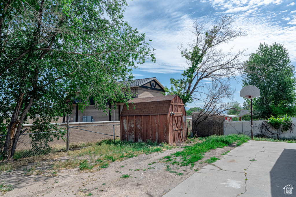 View of property exterior featuring a storage unit