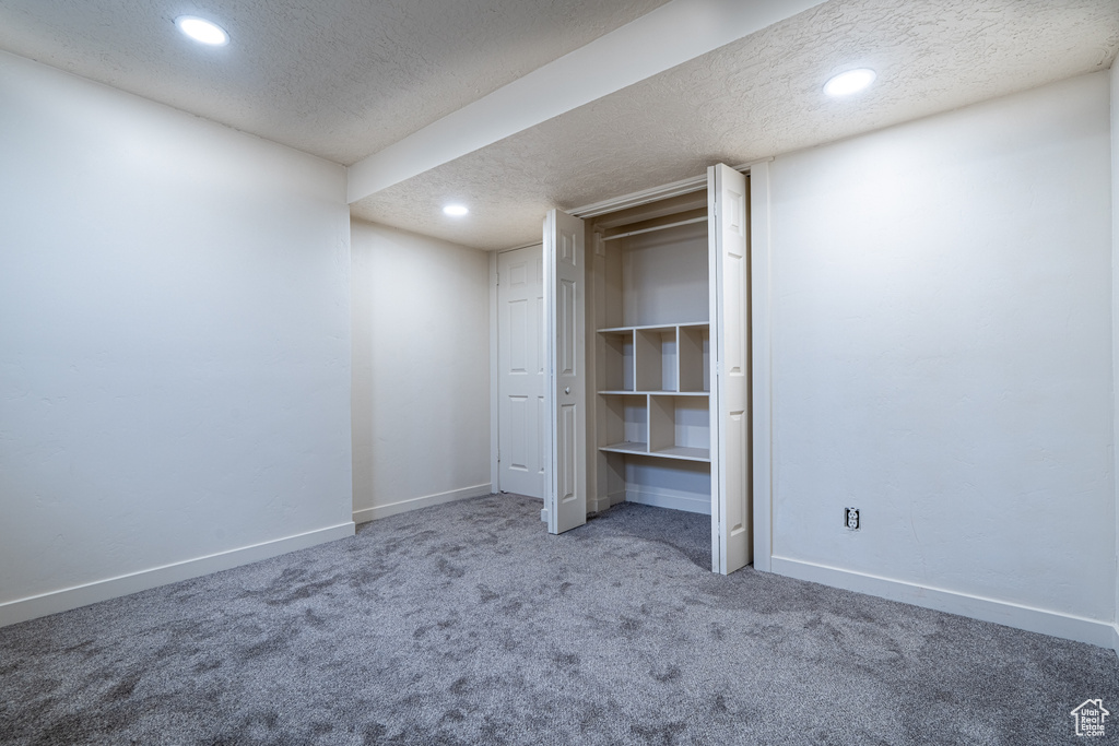Unfurnished bedroom with carpet floors, a textured ceiling, recessed lighting, and baseboards