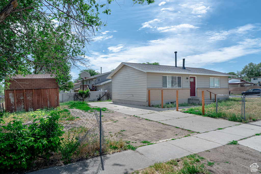 View of front facade with a fenced front yard and brick siding