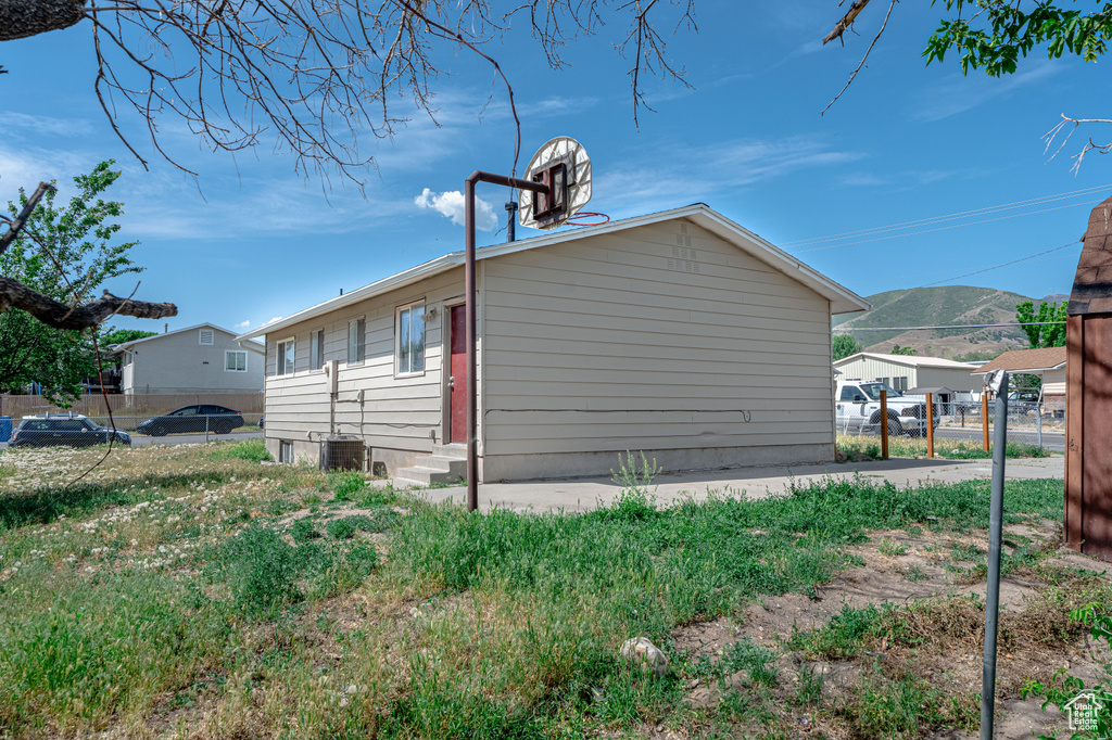 View of side of home featuring entry steps and a mountain view