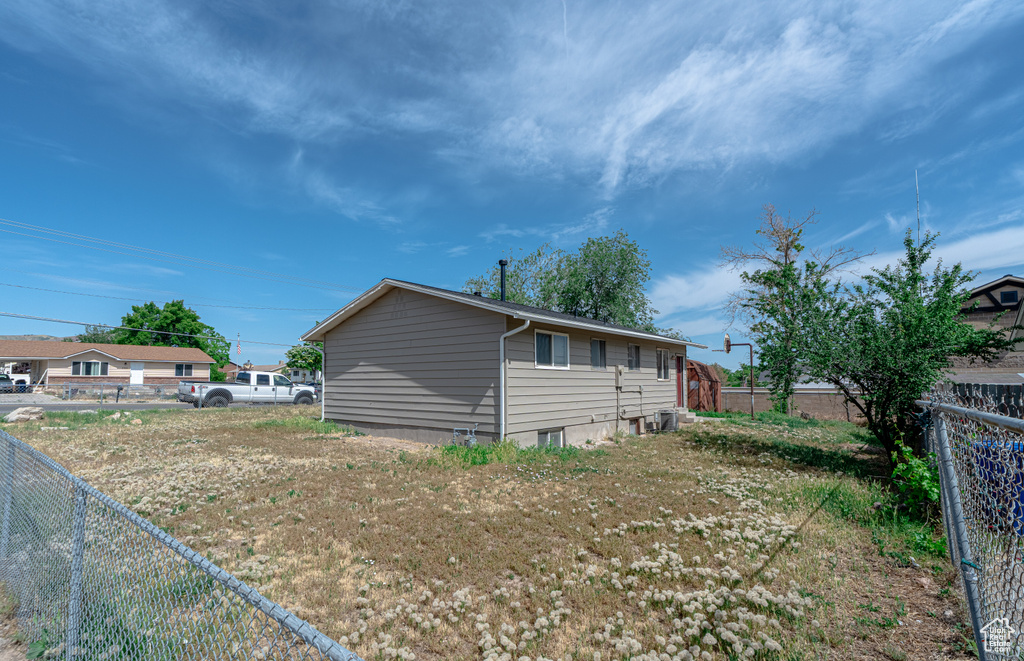 View of side of property with a fenced backyard