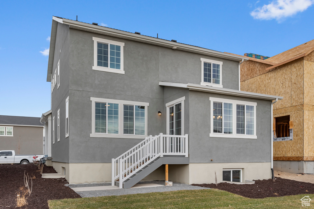 Rear view of house featuring stucco siding