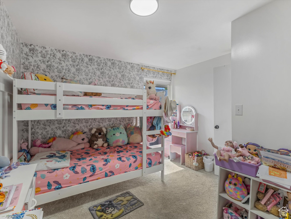 Bedroom featuring wallpapered walls and carpet