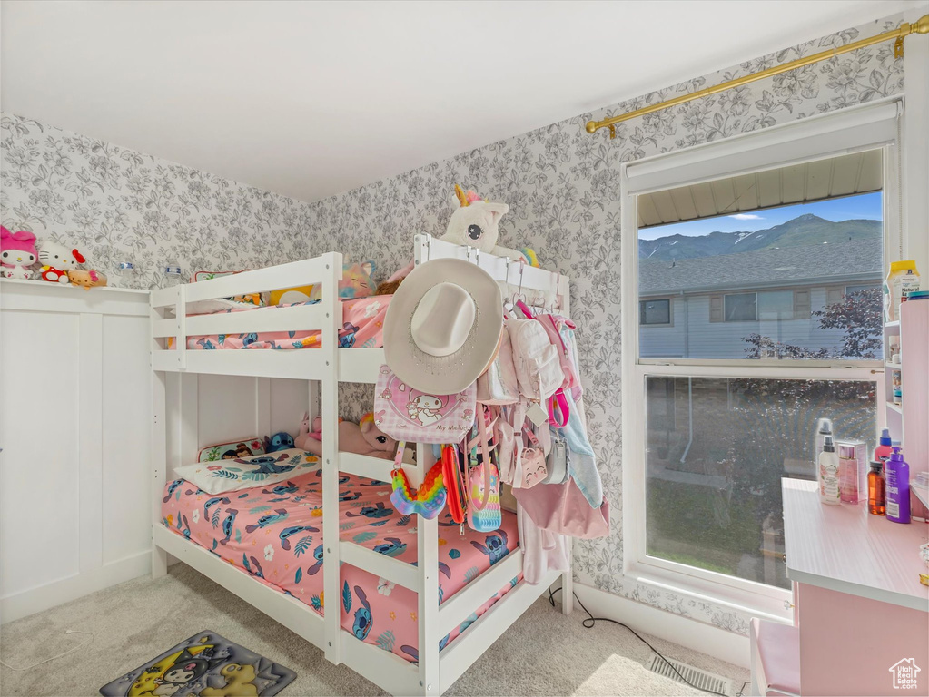 Bedroom with wallpapered walls and carpet flooring