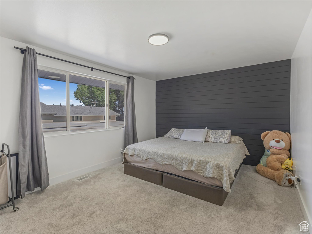 Carpeted bedroom featuring baseboards