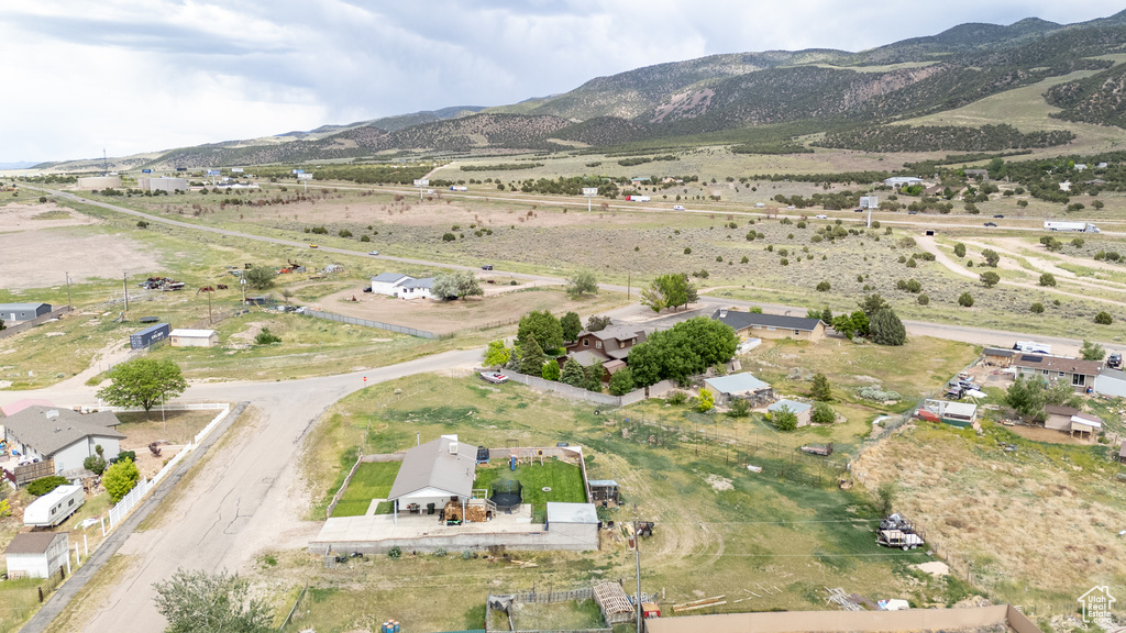 Aerial overview of property's location featuring a mountainous background and rural landscape