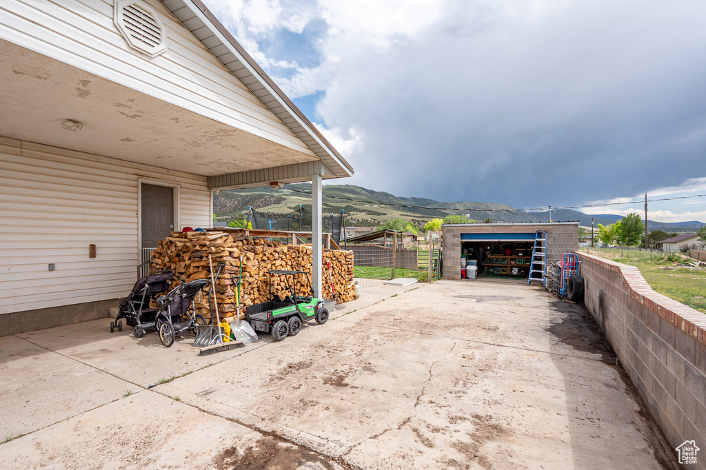 View of patio with a mountain view and an outdoor structure