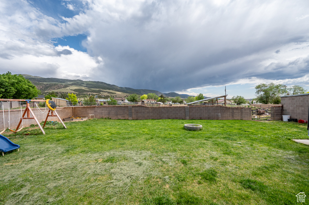 View of yard featuring a mountain view and a playground