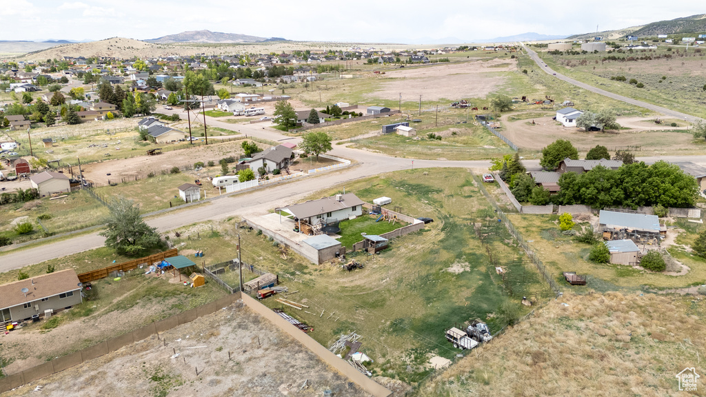 Aerial view of property and surrounding area with a mountainous background