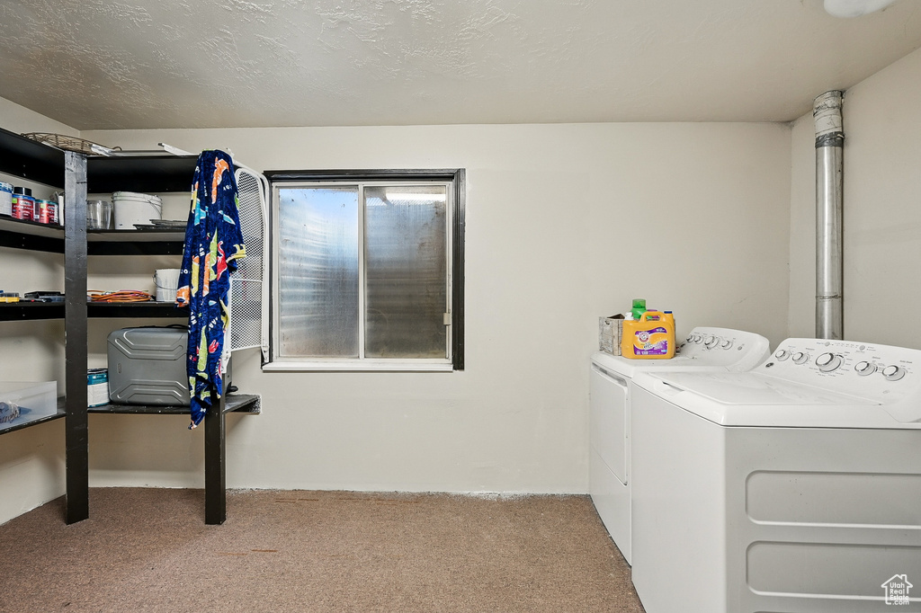 Laundry area with washing machine and dryer and carpet