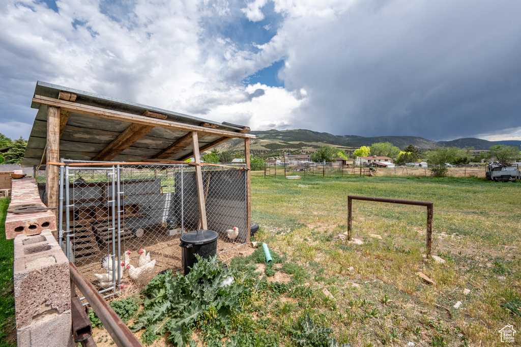 View of yard with a mountain view, exterior structure, and an outdoor structure