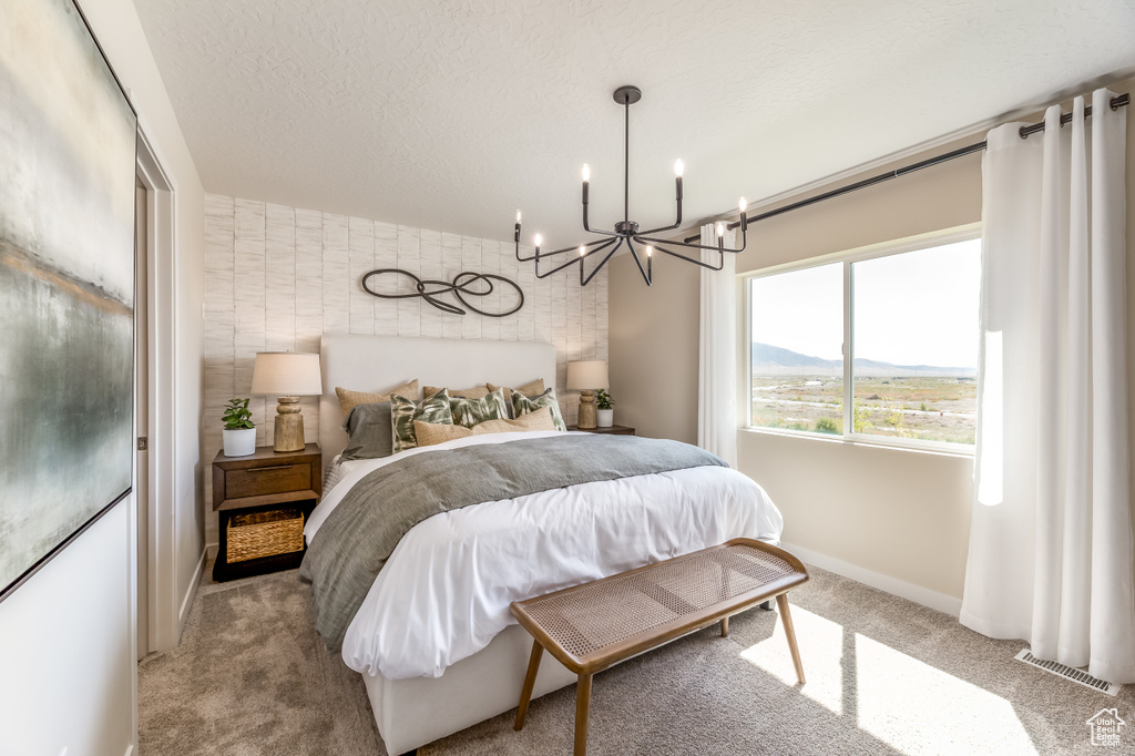 Bedroom with carpet floors, a chandelier, and baseboards