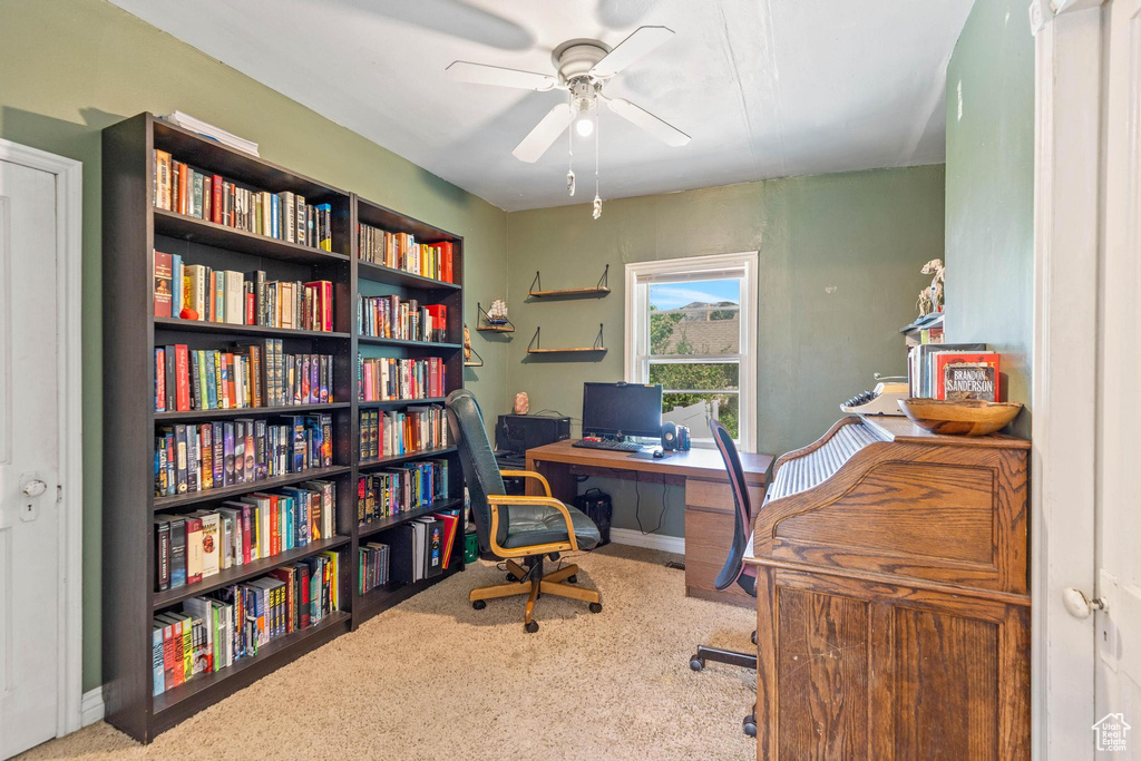 Office space with a ceiling fan, carpet, and baseboards