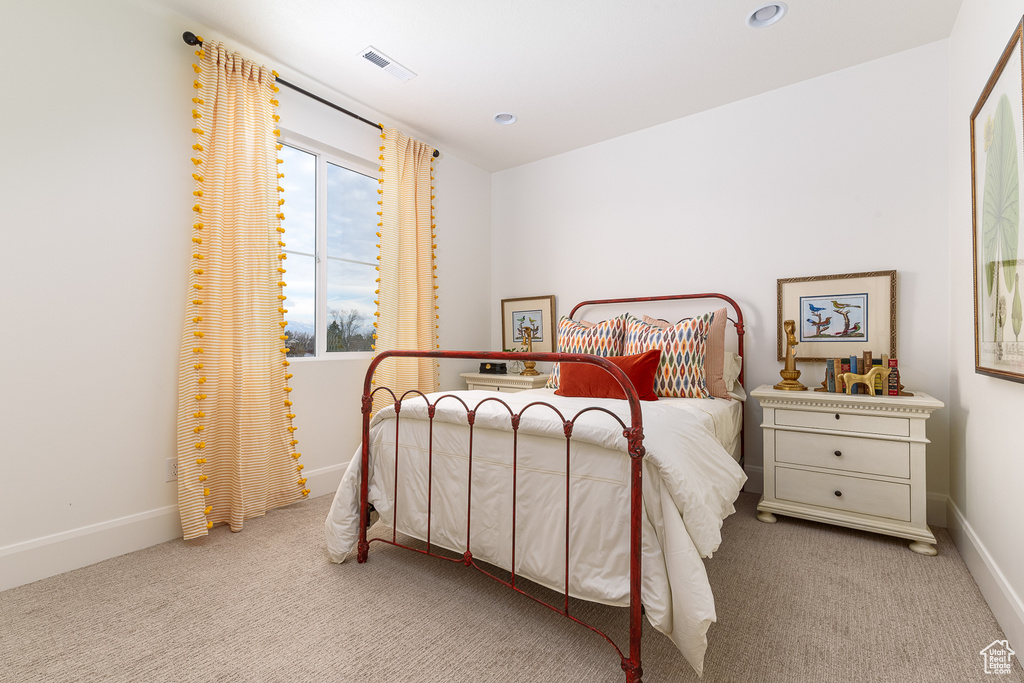 Carpeted bedroom with baseboards and recessed lighting