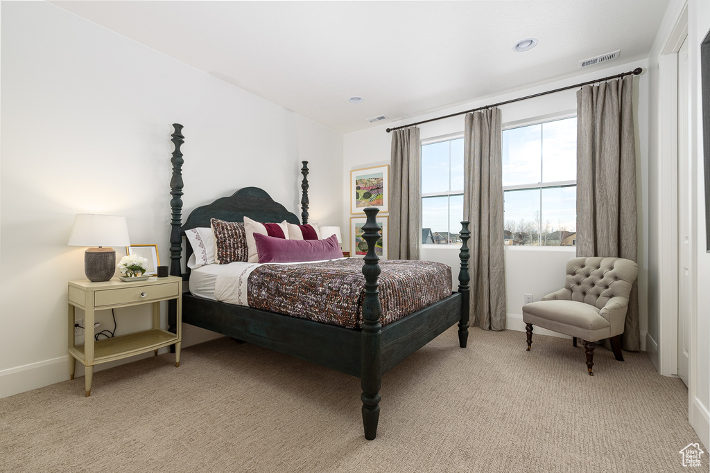 Bedroom with light carpet and baseboards