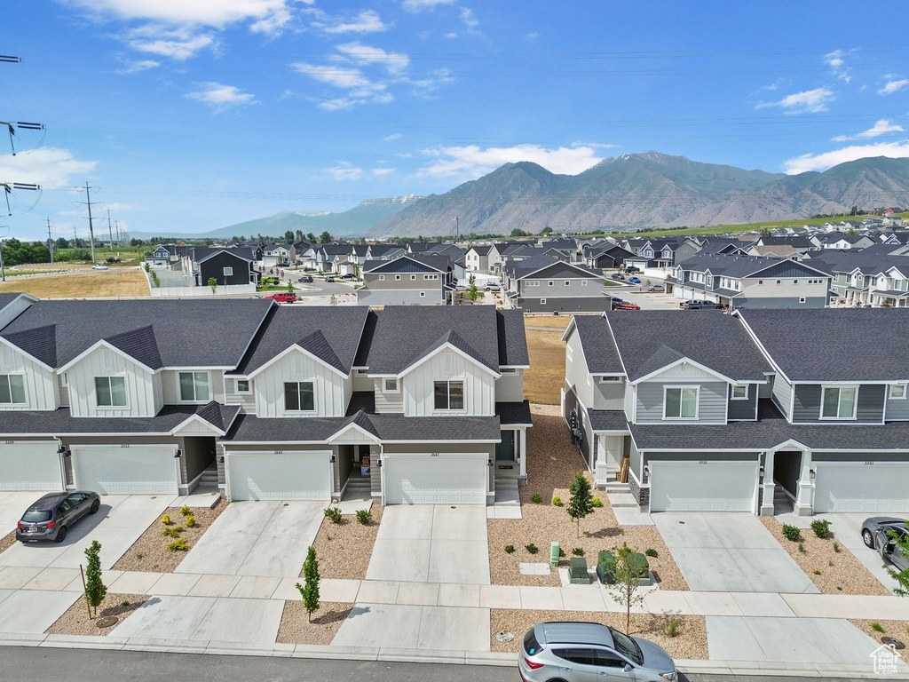 View of front of property with board and batten siding, a residential view, and driveway