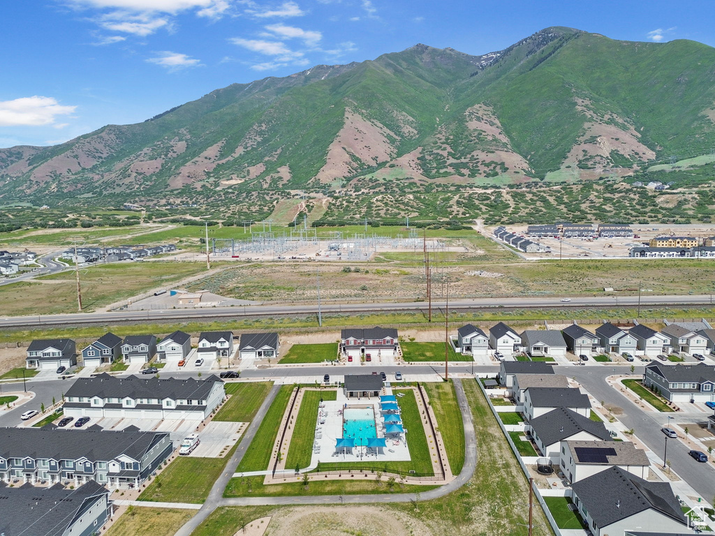 Aerial perspective of suburban area featuring a pool area and mountains