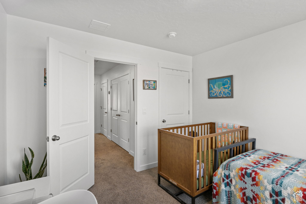 Bedroom with carpet flooring and baseboards