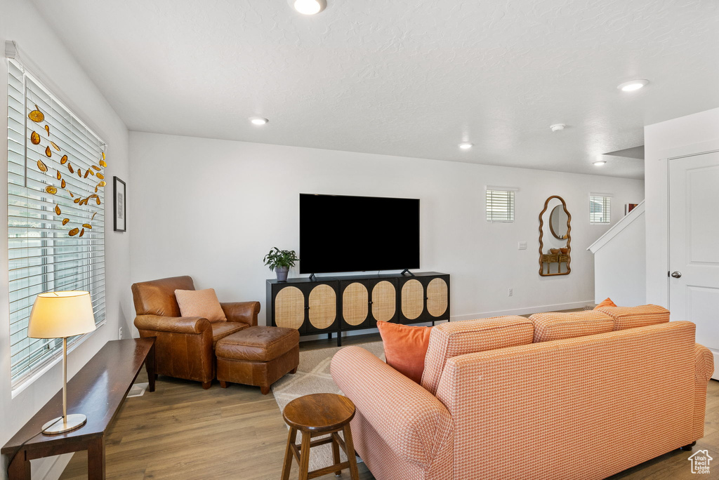 Living room featuring light wood-style floors, recessed lighting, and baseboards