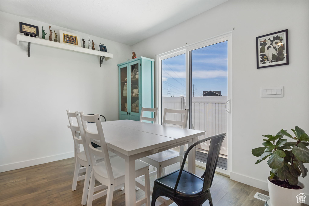 Dining space featuring baseboards and wood finished floors