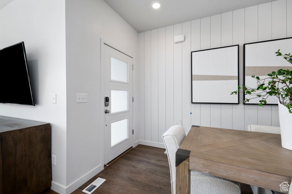 Foyer with dark wood finished floors, baseboards, and recessed lighting