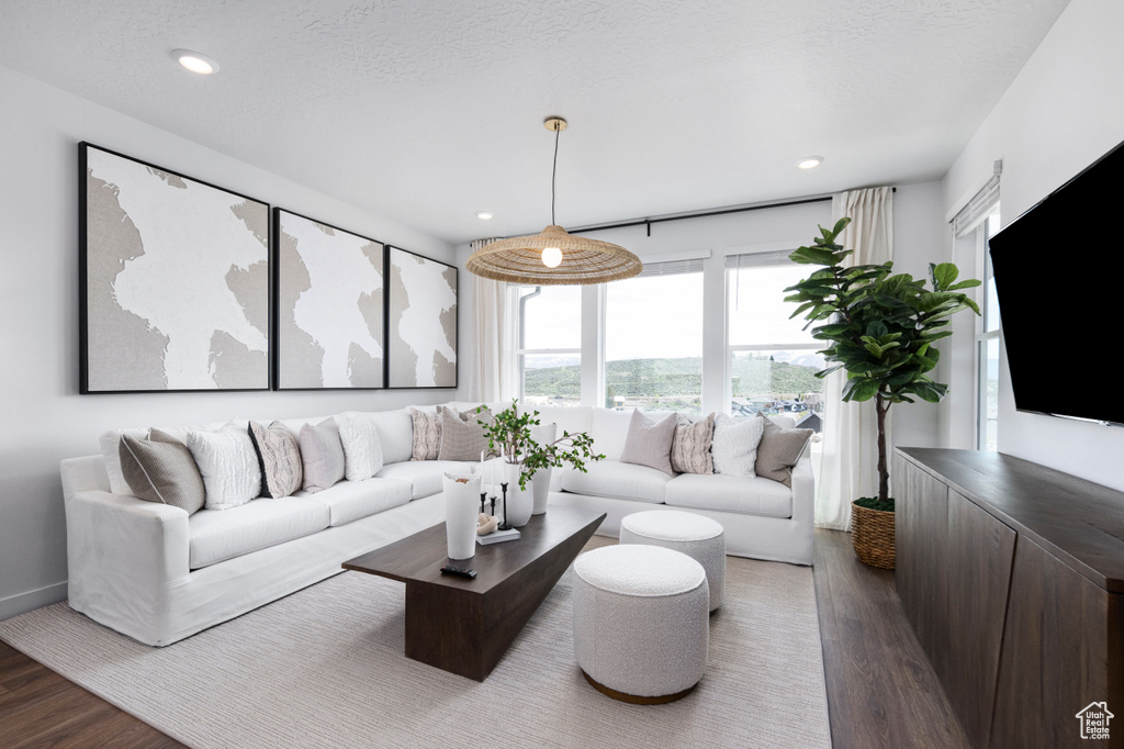 Living area featuring wood finished floors, recessed lighting, and baseboards