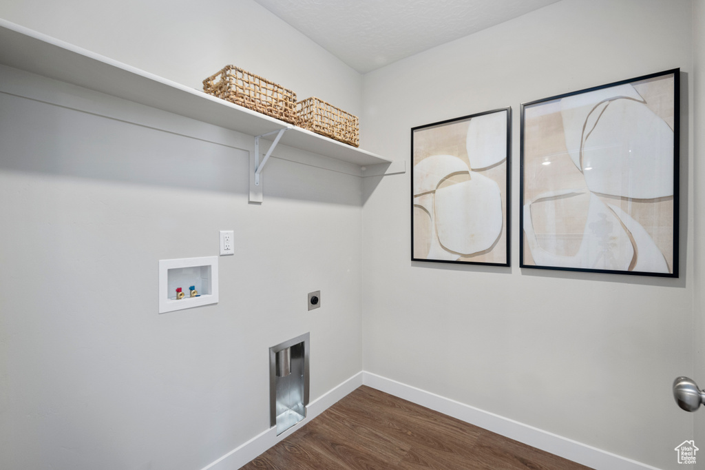 Washroom featuring baseboards, wood finished floors, hookup for a washing machine, and hookup for an electric dryer