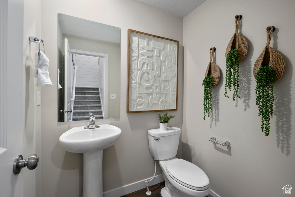 Bathroom featuring baseboards and toilet