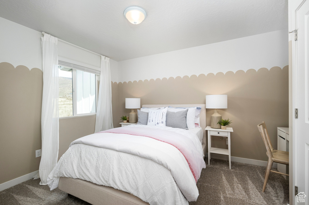 Bedroom featuring carpet floors and baseboards