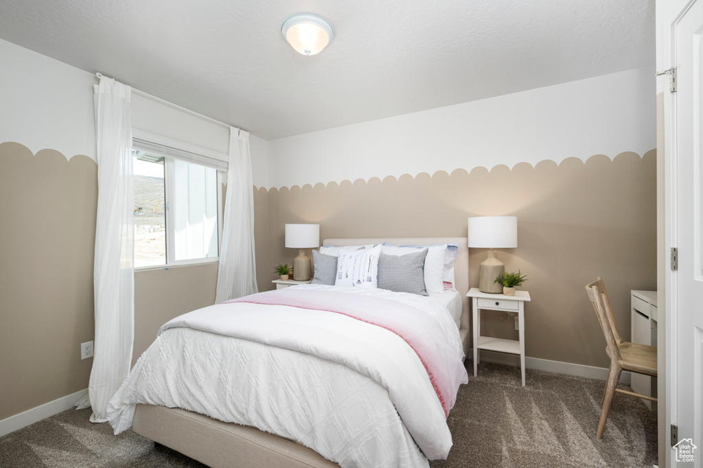 Bedroom with carpet flooring and baseboards