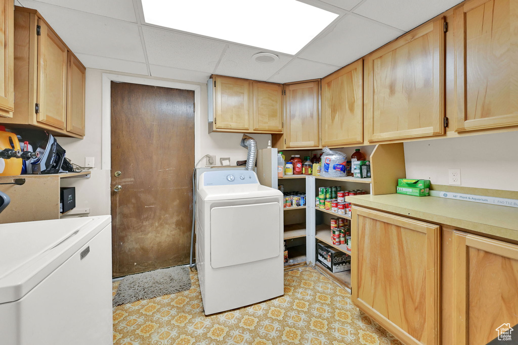 Laundry area with cabinet space and washing machine and dryer