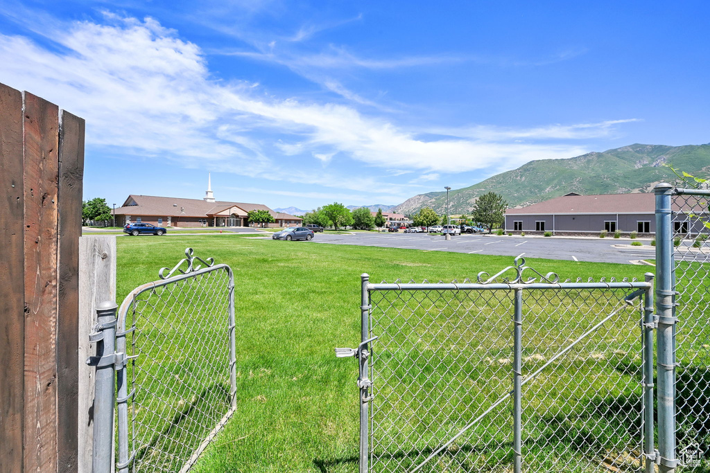 View of yard with a gate and a mountain view