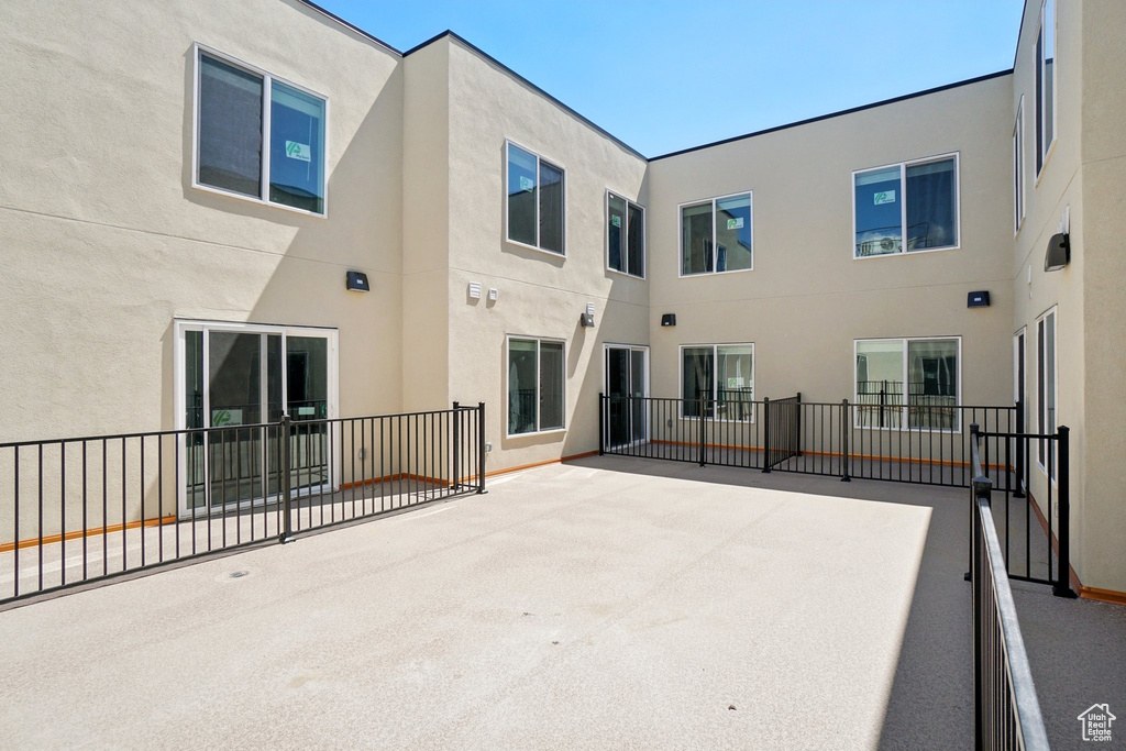 Back of property with stucco siding and a patio area