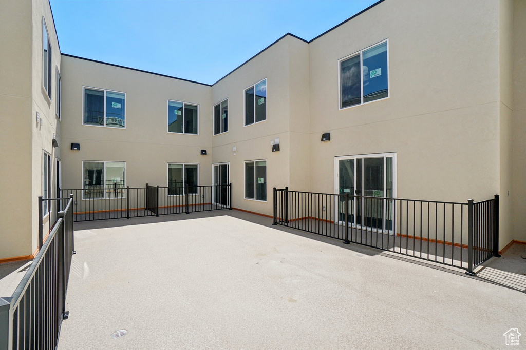 Back of property with a patio and stucco siding