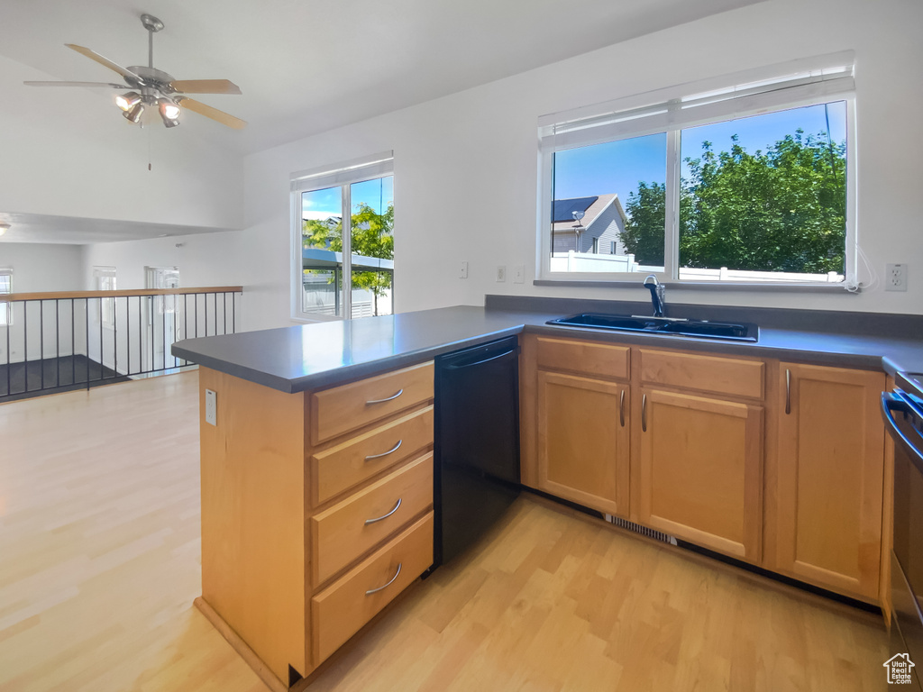 Kitchen with dishwasher, a sink, light wood-style flooring, ceiling fan, and a peninsula
